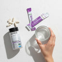 Aurora Glutathione supplement packaging with capsules and a glass on a white background